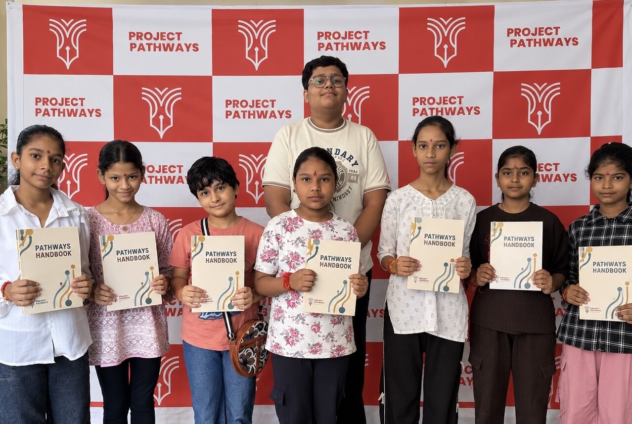 Students with the Pathways Handbook at a village drive